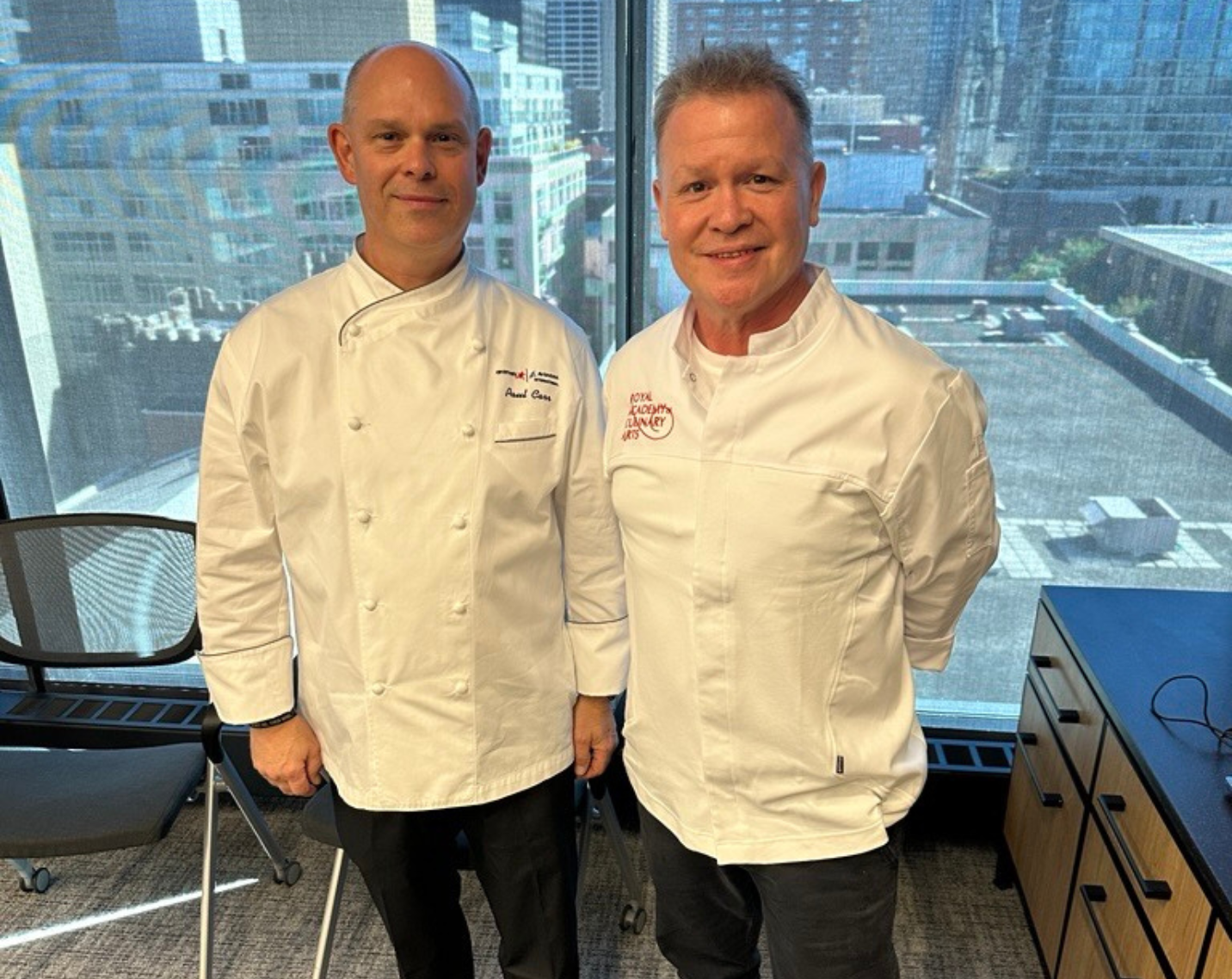 Two chefs standing in a room. 